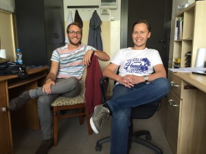 Alex, on the left, talking to Wojtek in the office.